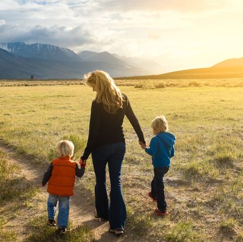 woman with children walking in valley